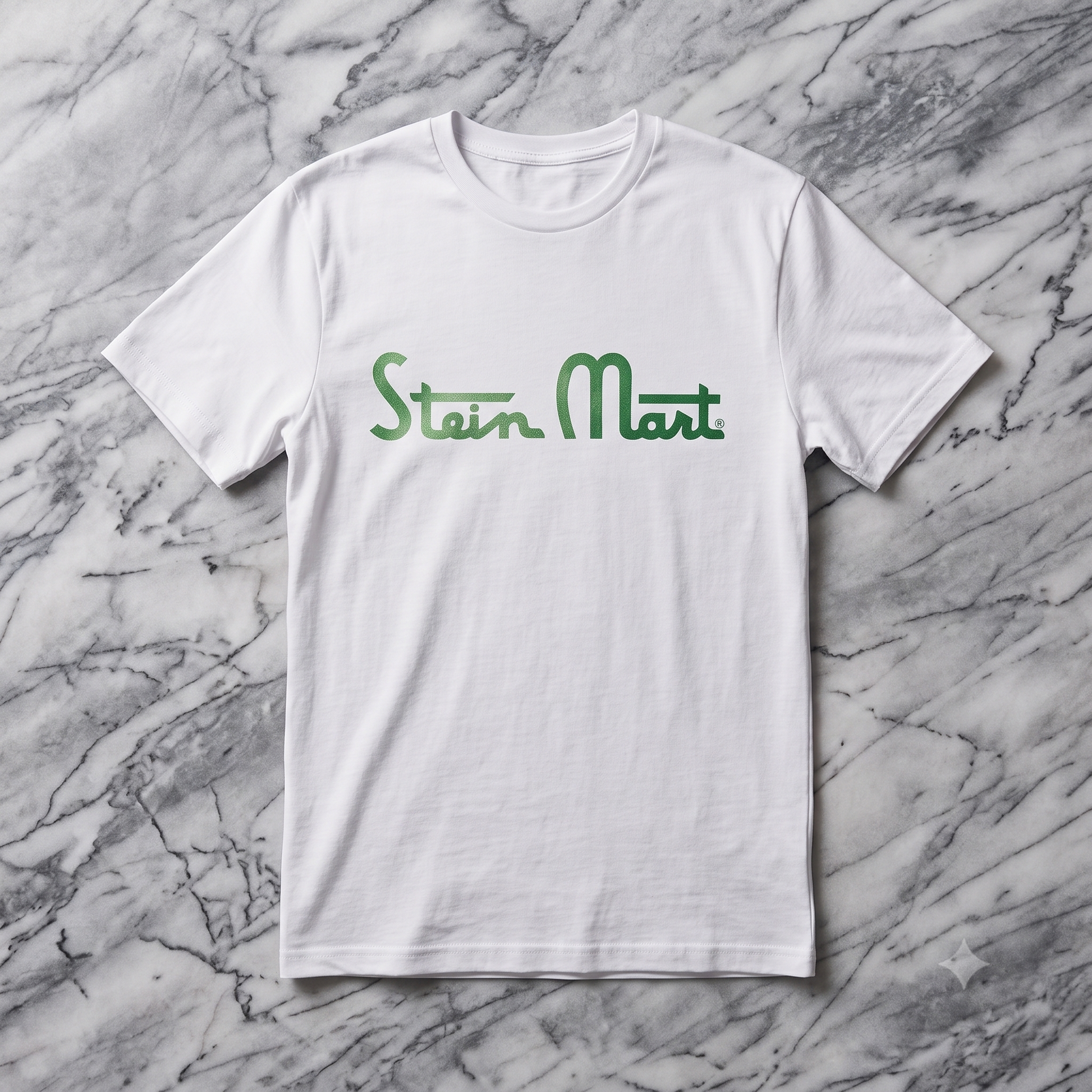Stein Mart Memorial Tee in white, flat lay on marble background
